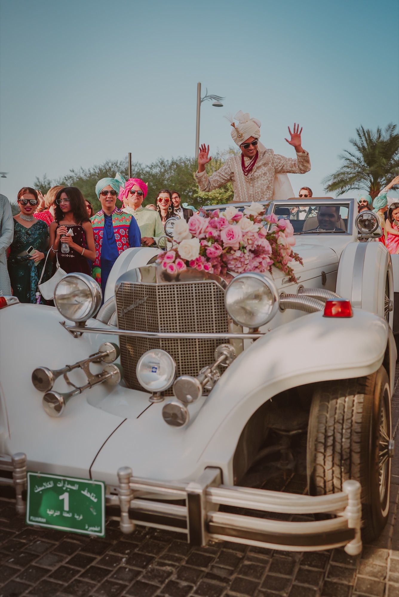 Groom arriving in a classic car at an Indian wedding baraat in Dubai